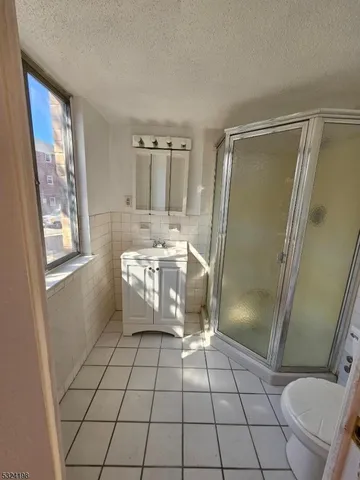 a bathroom with a sink a toilet and a shower