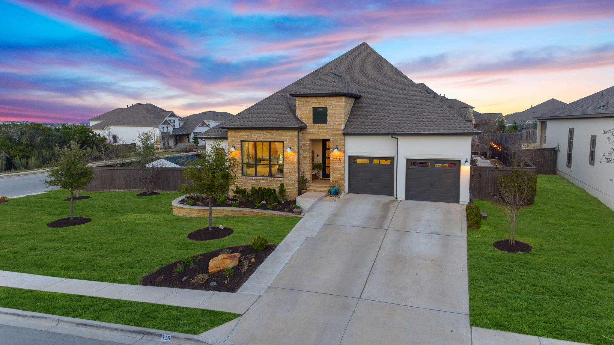 a front view of a house with a yard and garage