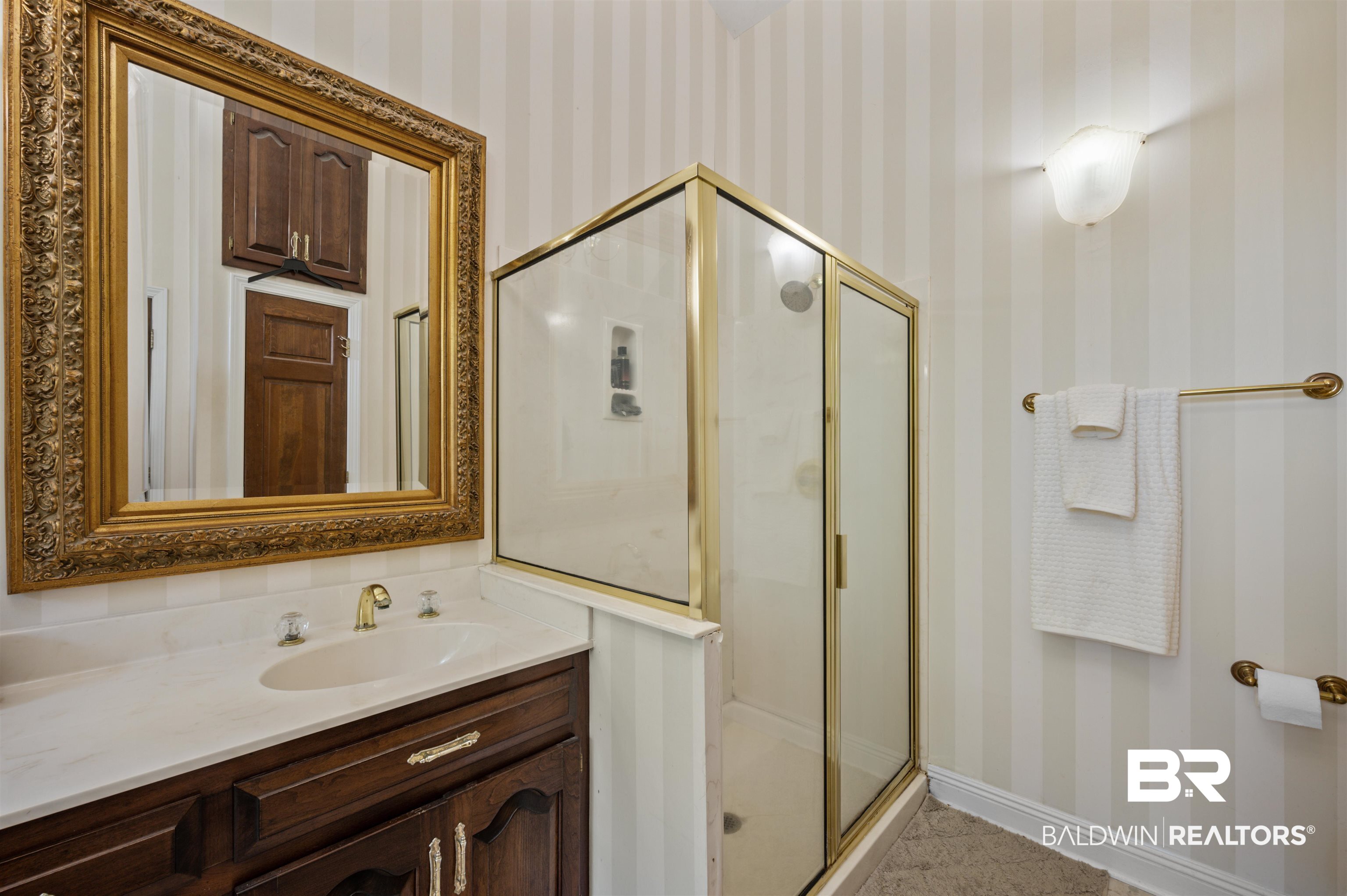 141 Blue Ridge Drive Monroeville, AL 36460 - Photo 24 of 40 Full bathroom with wallpapered walls, vanity, a shower stall, and tile patterned floors