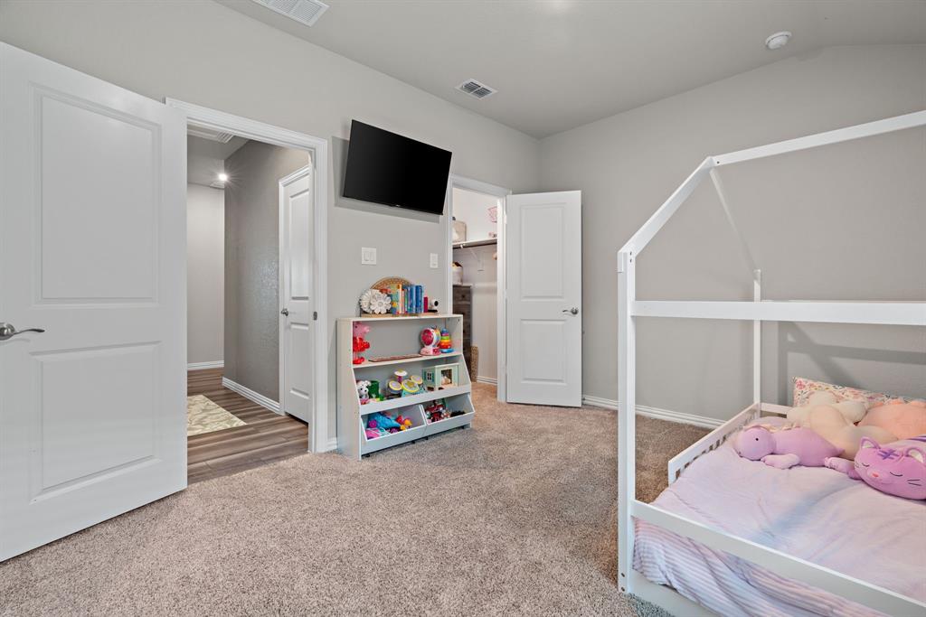 3112 Kingsgarden Road Denton, TX 76207 - Photo 25 of 38 Carpeted interior space featuring light gray walls, white trim, and a white paneled door