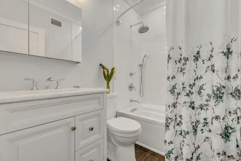 a bathroom with a sink toilet and shower