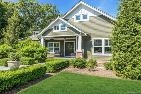 a front view of a house with a yard and porch
