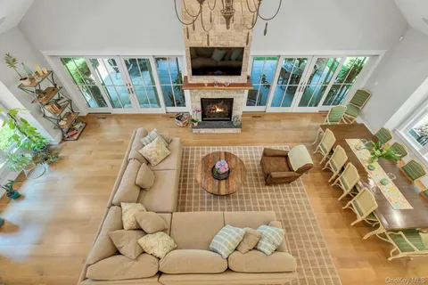 a living room with a couch a flat screen tv and a floor to ceiling window