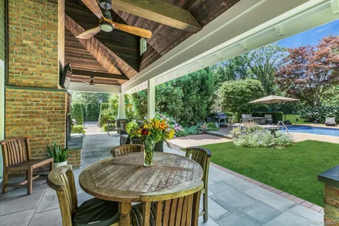 a view of a patio with a table and chairs and potted plants