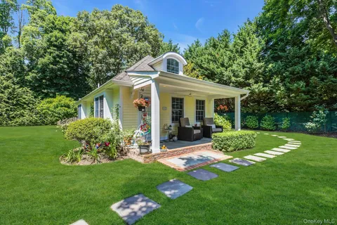 a view of a house with a yard and sitting area