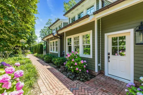 a flower garden in front of a house