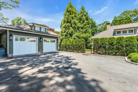 a view of a house with a yard and garage