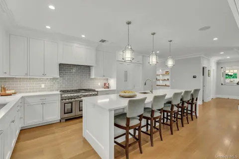 a large kitchen with a table and chairs