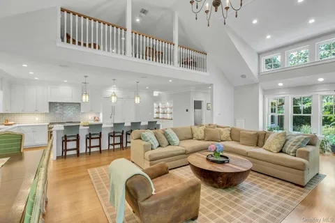 a large kitchen with stainless steel appliances granite countertop a stove and a large kitchen island