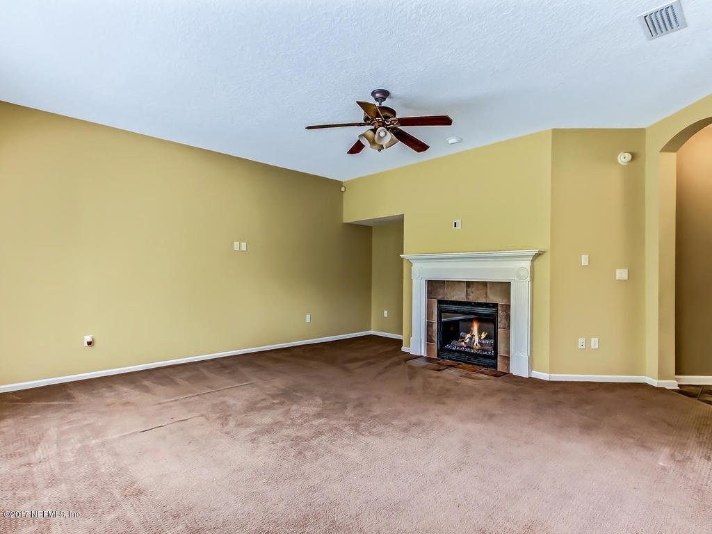9158 Raptor Drive Jacksonville, FL 32221 - Photo 17 of 45 a view of an empty room with a fireplace