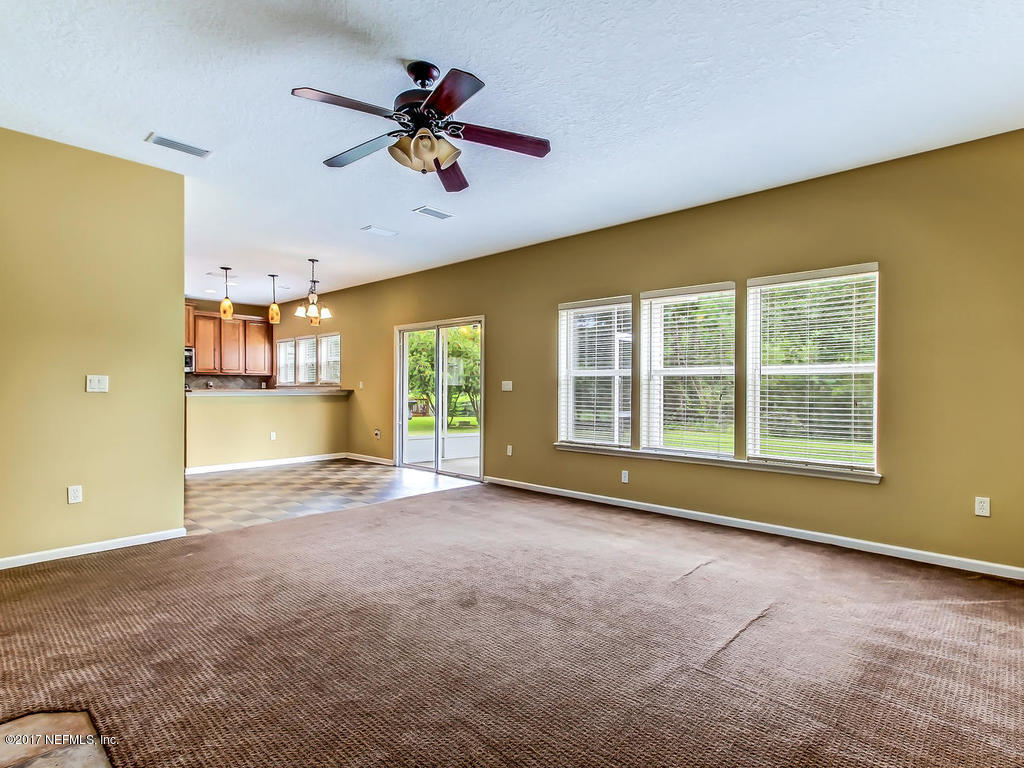 9158 Raptor Drive Jacksonville, FL 32221 - Photo 18 of 45 a view of a livingroom with a ceiling fan and window