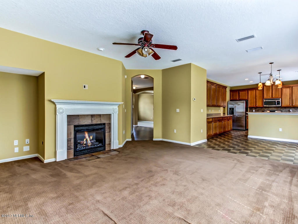 9158 Raptor Drive Jacksonville, FL 32221 - Photo 19 of 45 a view of an empty room with a fireplace and window