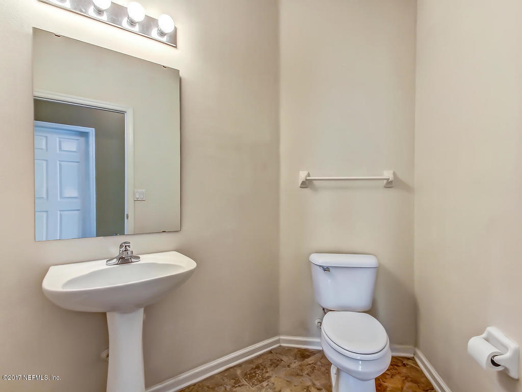 9158 Raptor Drive Jacksonville, FL 32221 - Photo 20 of 45 a bathroom with a sink toilet and a mirror