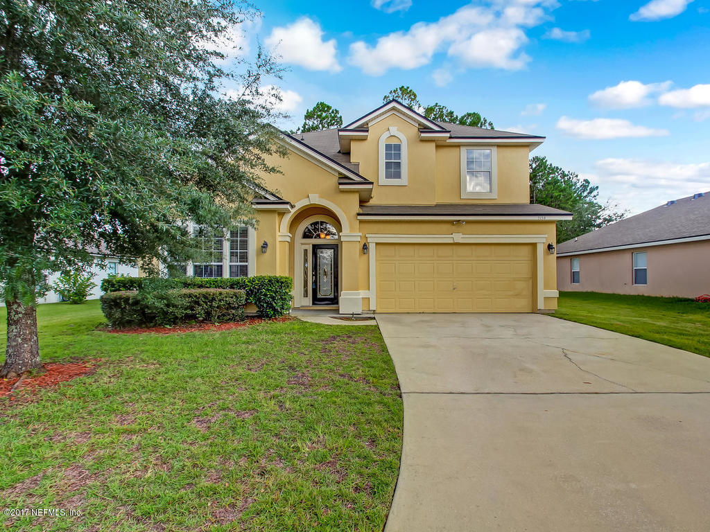 9158 Raptor Drive Jacksonville, FL 32221 - Photo 28 of 45 a front view of a house with a yard and garage