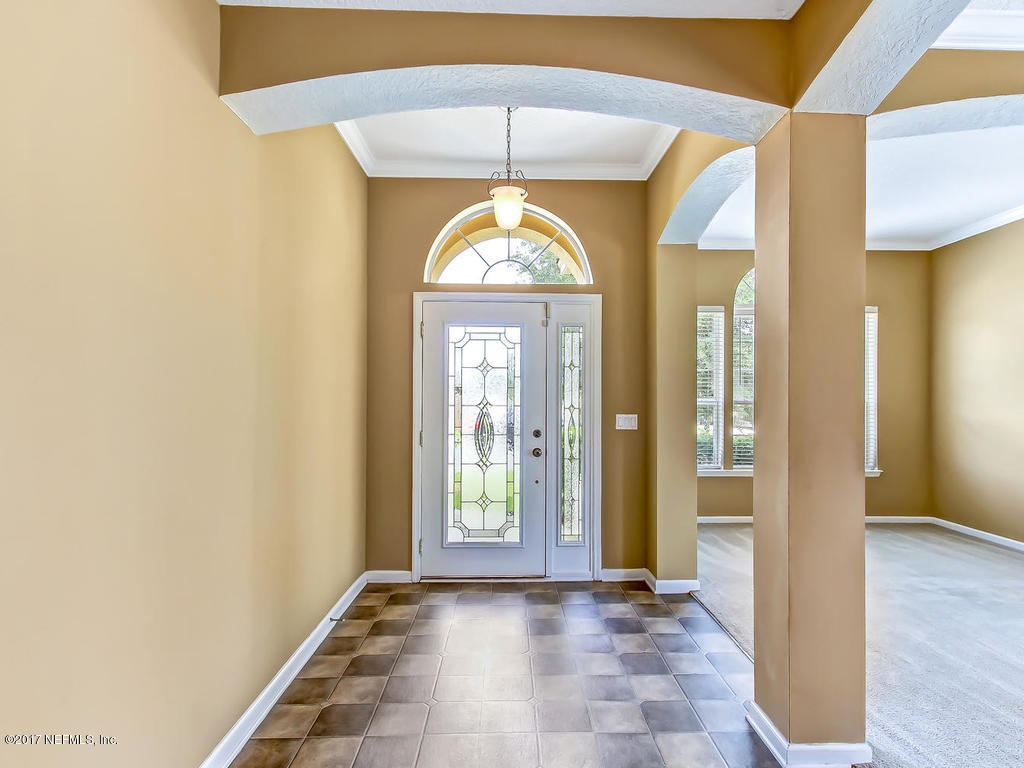 9158 Raptor Drive Jacksonville, FL 32221 - Photo 3 of 45 a view of entryway with a front door and wooden floor