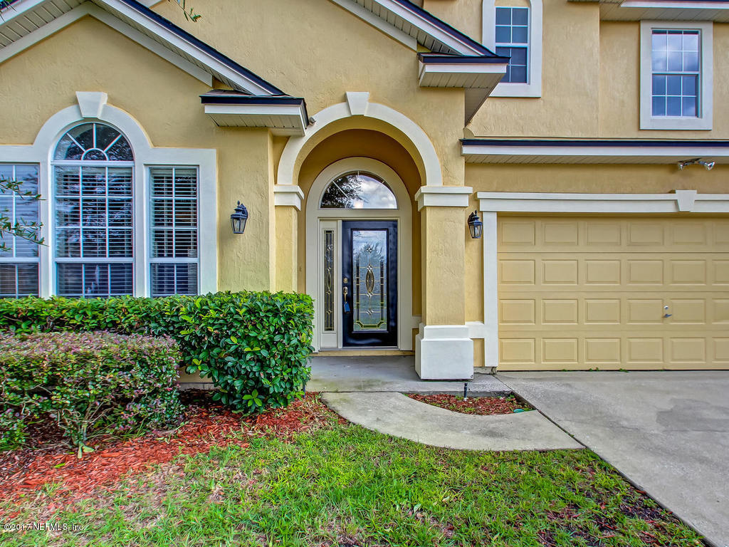 9158 Raptor Drive Jacksonville, FL 32221 - Photo 44 of 45 a front view of a house with garden