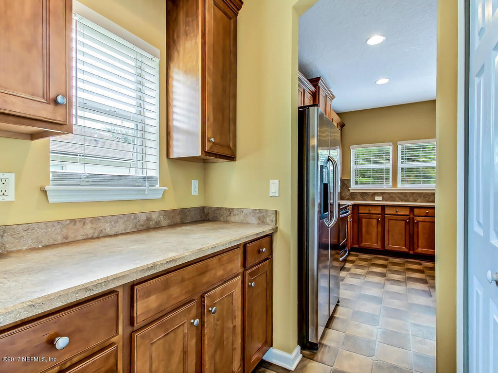9158 Raptor Drive Jacksonville, FL 32221 - Photo 9 of 45 a kitchen that has a sink and a stove