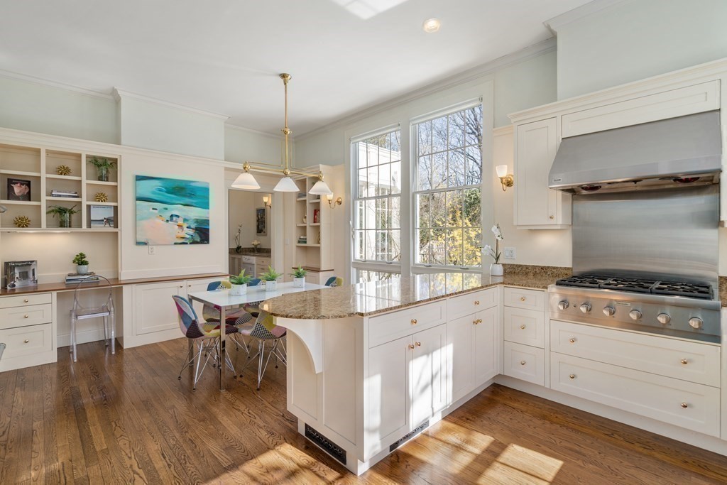 386 Commonwealth Avenue Newton, MA 02467 - Photo 13 of 28 a kitchen with white cabinets and wooden floor