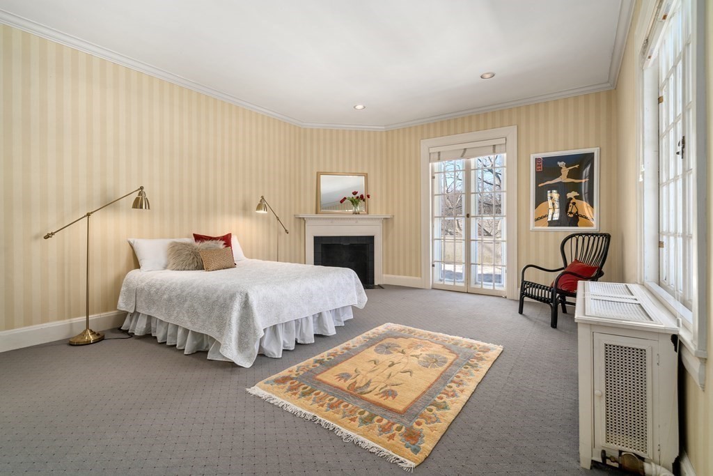 386 Commonwealth Avenue Newton, MA 02467 - Photo 17 of 28 a spacious bedroom with a bed a table and painting