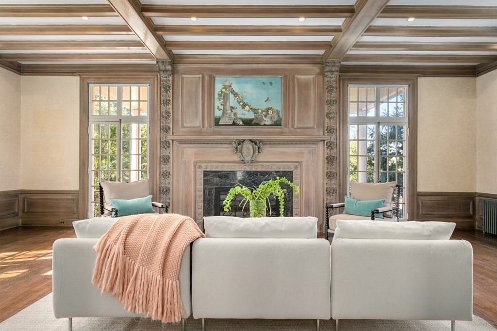 386 Commonwealth Avenue Newton, MA 02467 - Photo 2 of 28 a living room with a bed a fireplace and a large window