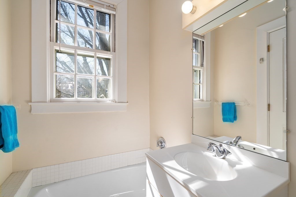 386 Commonwealth Avenue Newton, MA 02467 - Photo 22 of 28 a bathroom with a sink and a mirror