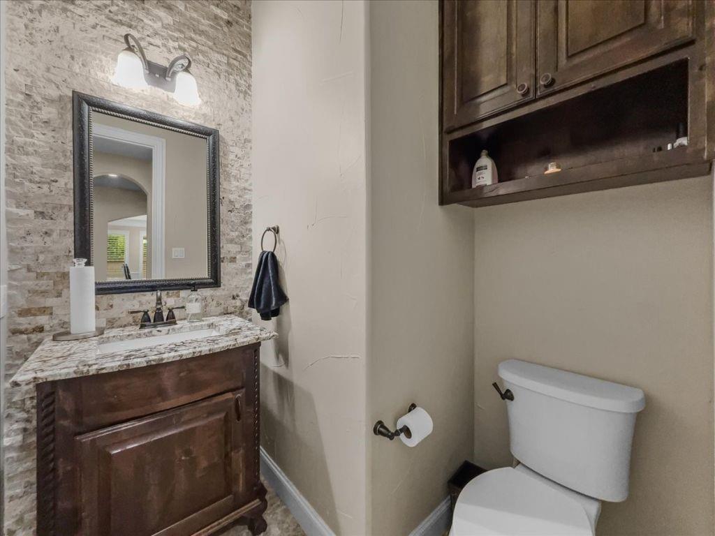 2832 Mona Vale Road Trophy Club, TX 76262 - Photo 15 of 37 a bathroom with a granite countertop toilet sink and mirror