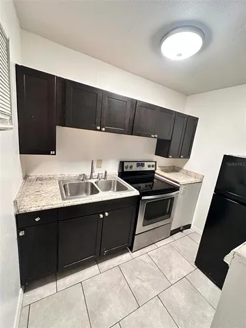 a kitchen with a sink and cabinets