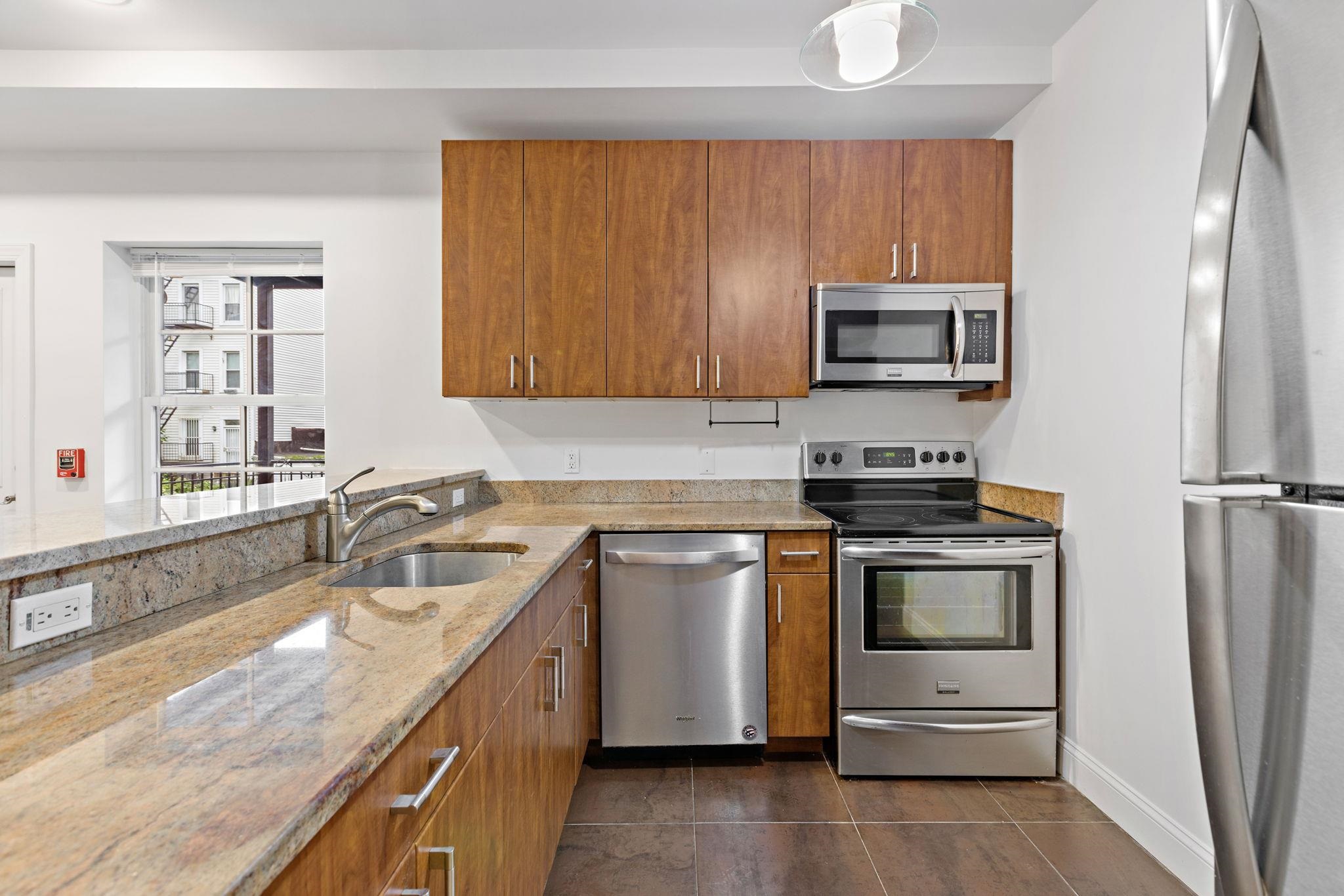 a kitchen with a sink stove and microwave