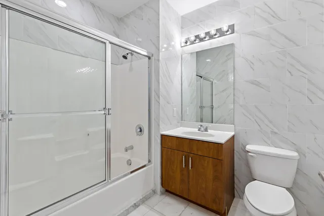 a bathroom with a toilet a sink and shower