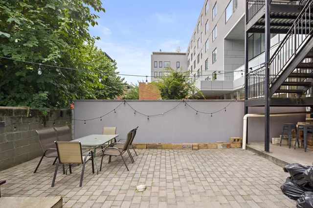 a backyard of a house with table and chairs