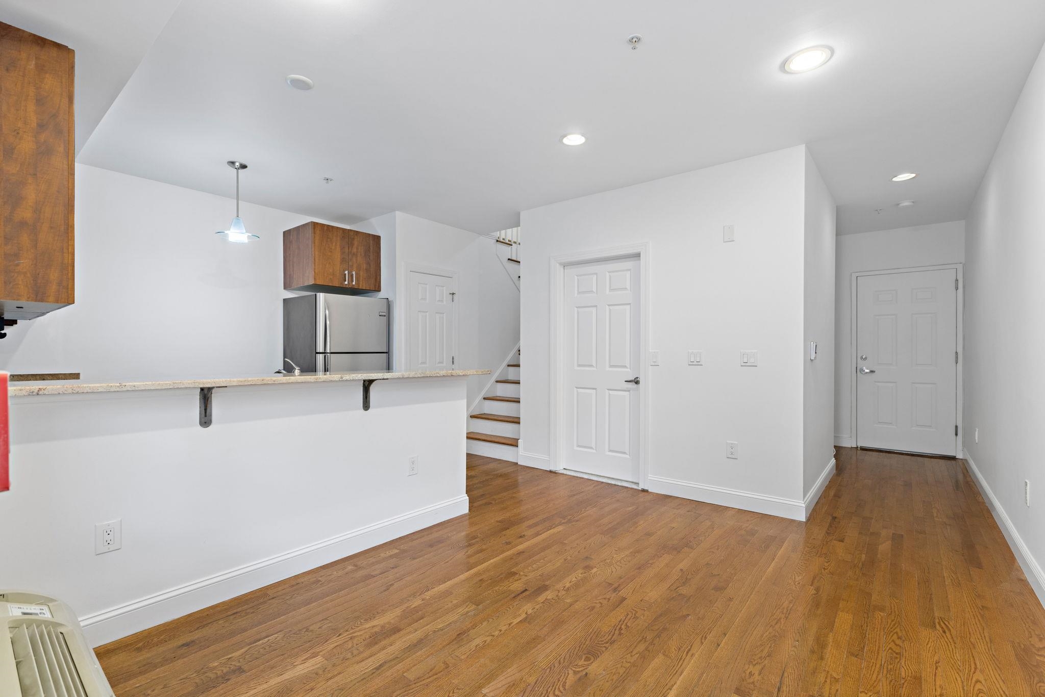 415 Jackson Street, Unit 1R Hoboken, NJ 07030 - Photo 3 of 14 a view of a kitchen with a sink and a refrigerator