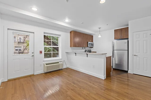 a view of kitchen with cabinets and wooden floor