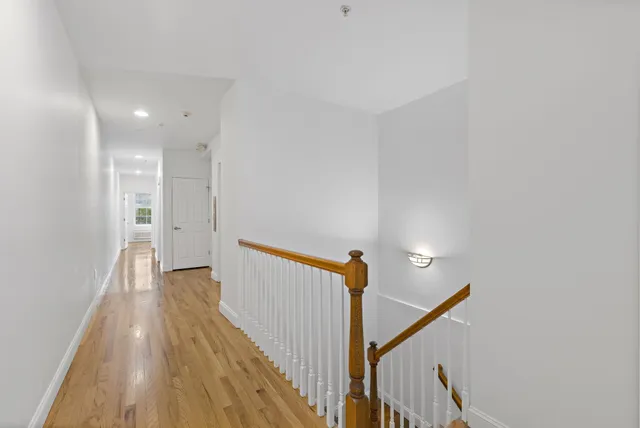 a view of a hallway with wooden floor