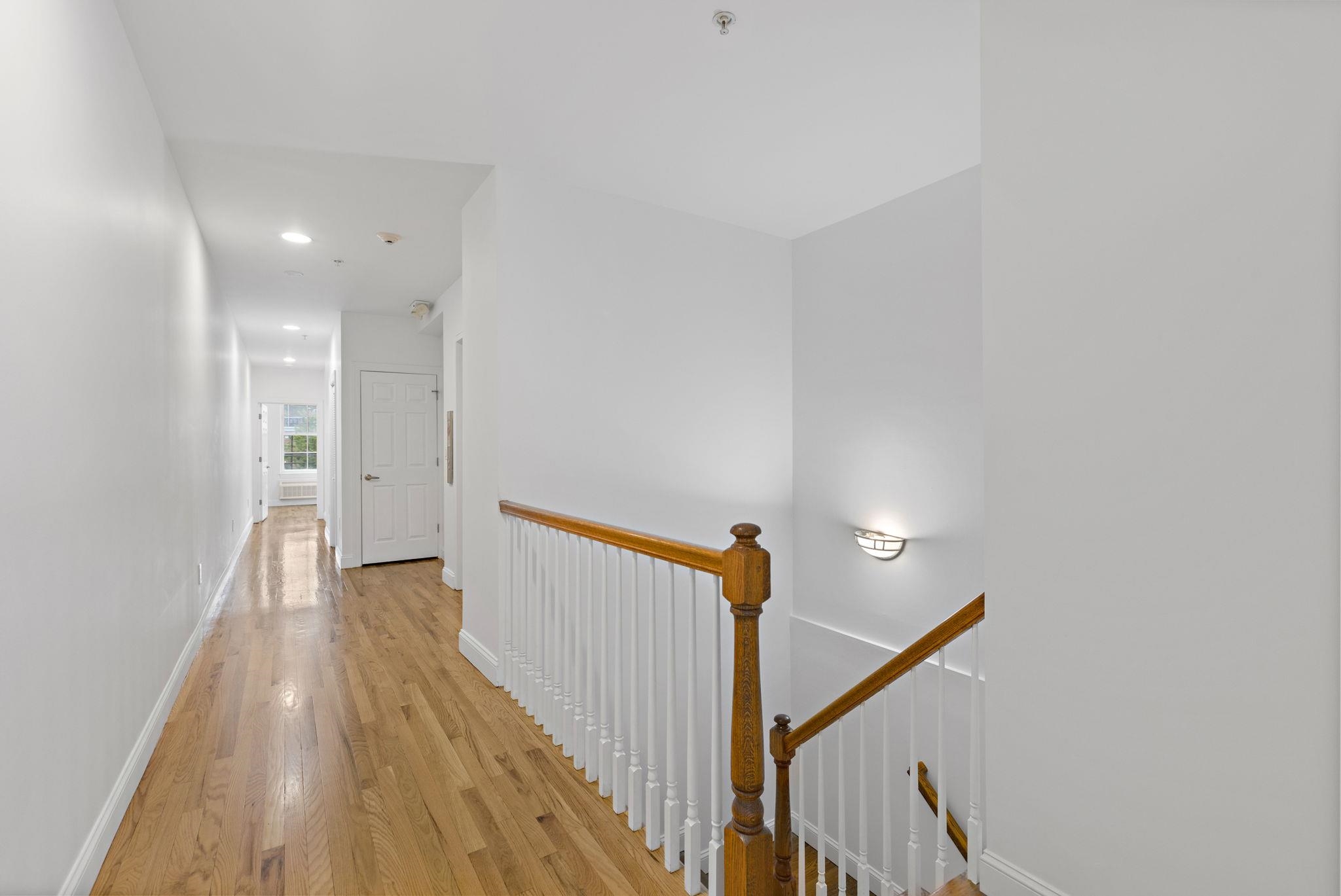 415 Jackson Street, Unit 1R Hoboken, NJ 07030 - Photo 6 of 14 a view of a hallway with wooden floor