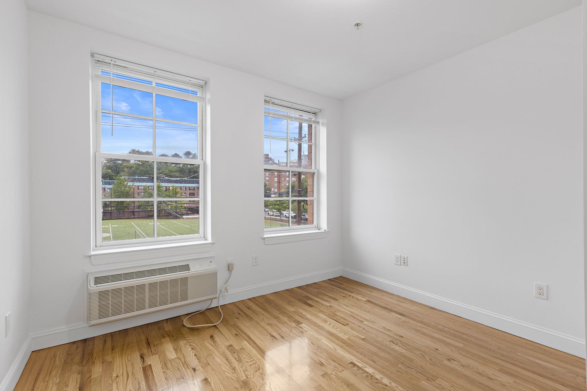 415 Jackson Street, Unit 1R Hoboken, NJ 07030 - Photo 10 of 14 a view of an empty room with a window