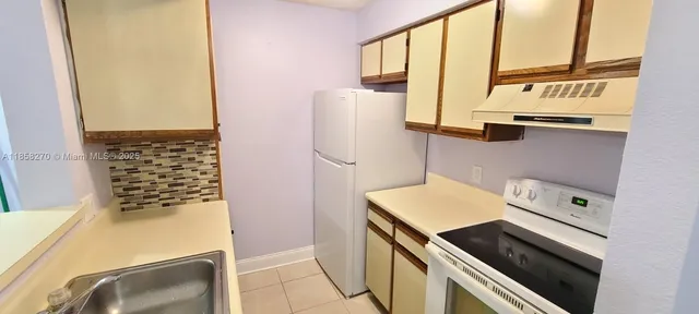 a view of a kitchen with a sink and a window