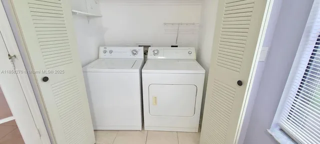 an empty room with a chandelier fan