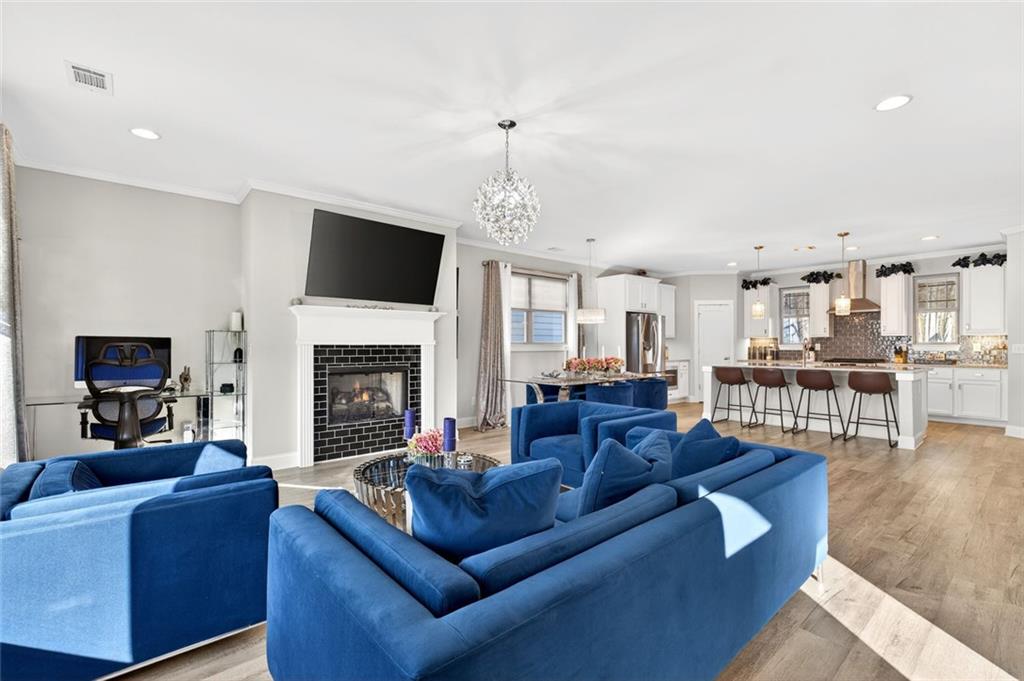 5259 Cloud Street Stone Mountain, GA 30083 - Photo 16 of 38 a living room with furniture a flat screen tv and a fireplace