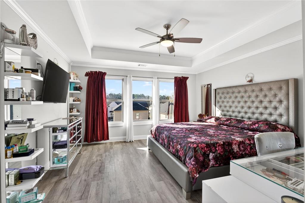 5259 Cloud Street Stone Mountain, GA 30083 - Photo 24 of 38 a bedroom with a bed and a flat tv screen on dresser