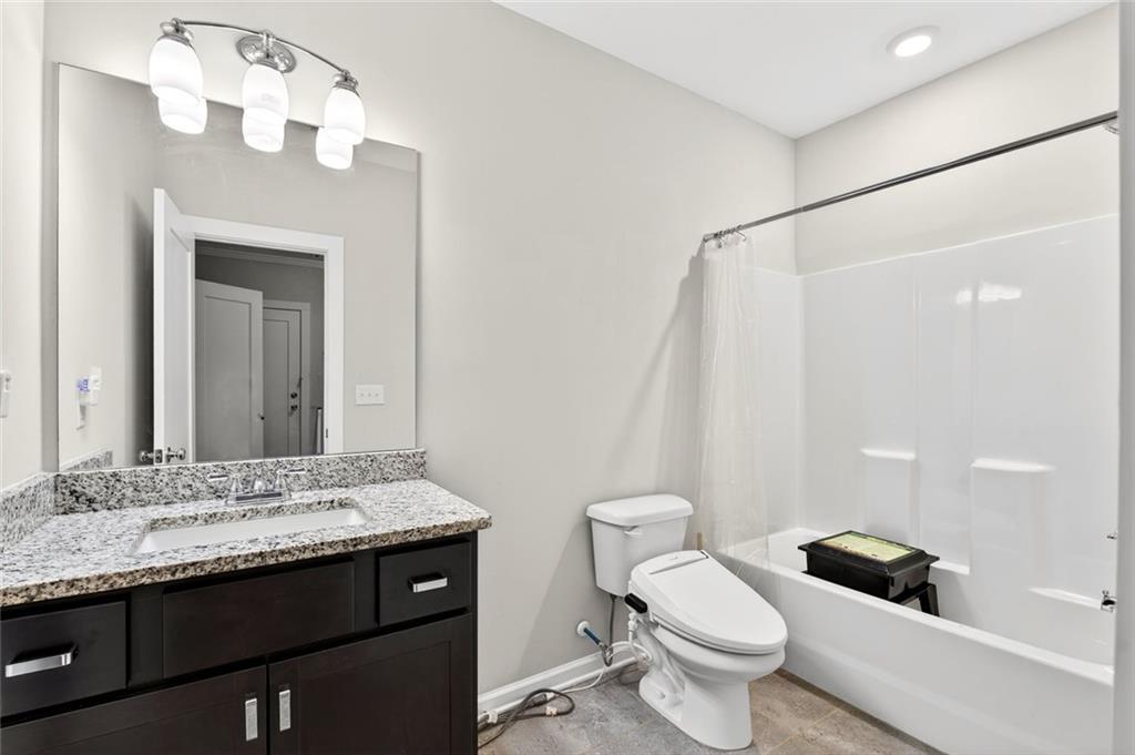 5259 Cloud Street Stone Mountain, GA 30083 - Photo 29 of 38 a bathroom with a granite countertop sink toilet and shower