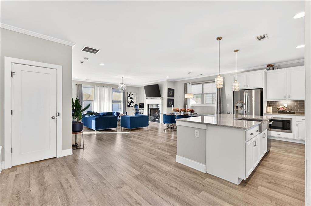 5259 Cloud Street Stone Mountain, GA 30083 - Photo 6 of 38 a large kitchen with stainless steel appliances and wooden cabinets