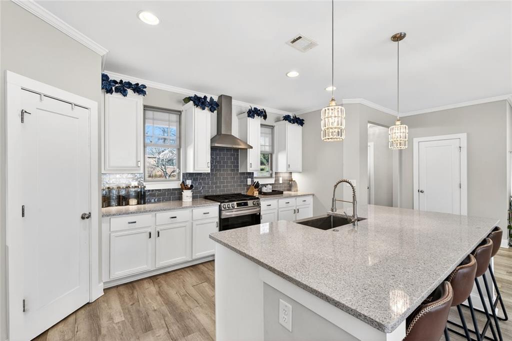 5259 Cloud Street Stone Mountain, GA 30083 - Photo 9 of 38 a kitchen with granite countertop a sink a stove and cabinets
