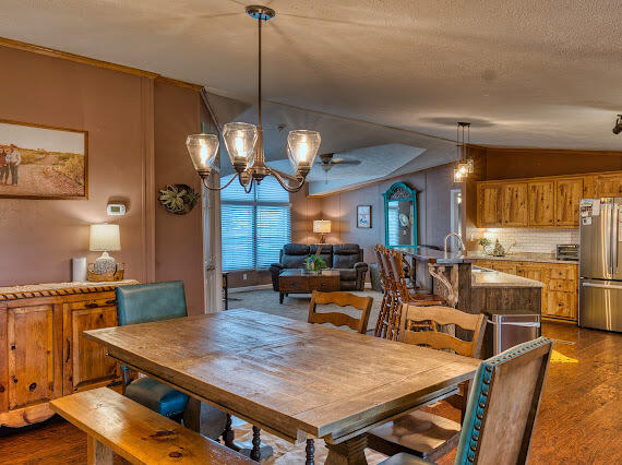 6341 Farm Private Road Levelland, TX 79336 - Photo 10 of 46 a view of a dining room with furniture a chandelier and wooden floor