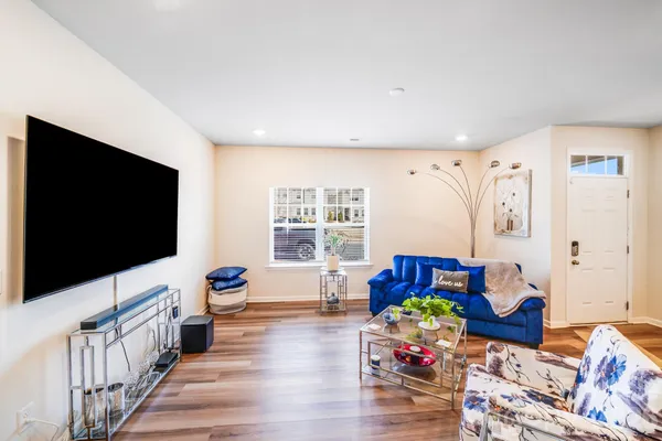 a bedroom with furniture and a flat screen tv