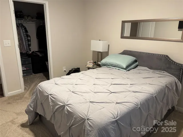 a large white bed in a white room