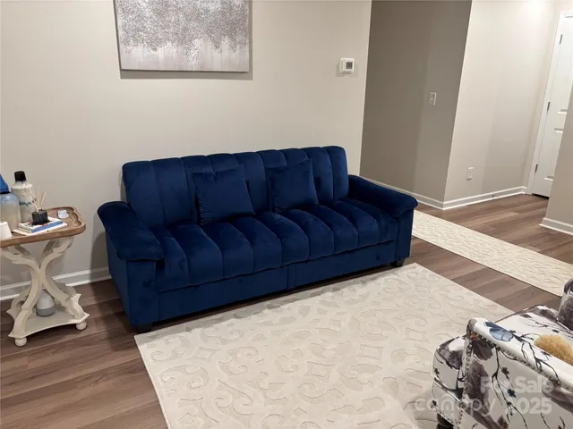 a living room with a couch and a wooden floor