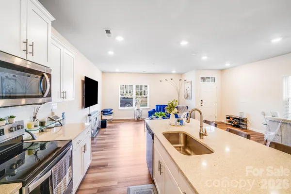 a kitchen that has a lot of cabinets a sink and a stove in it