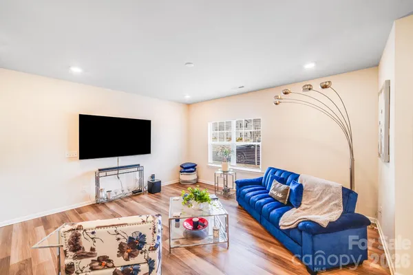a bedroom with furniture and a flat screen tv