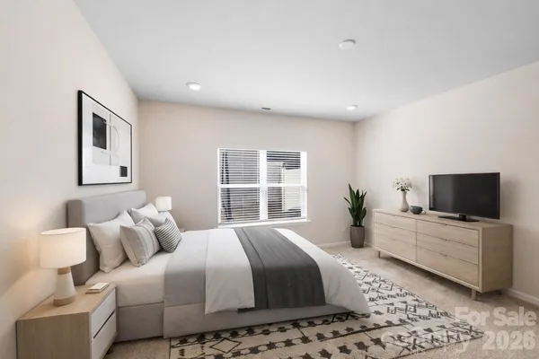 a spacious bedroom with a large bed and a flat screen tv
