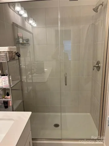 a bathroom with a shower and a sink